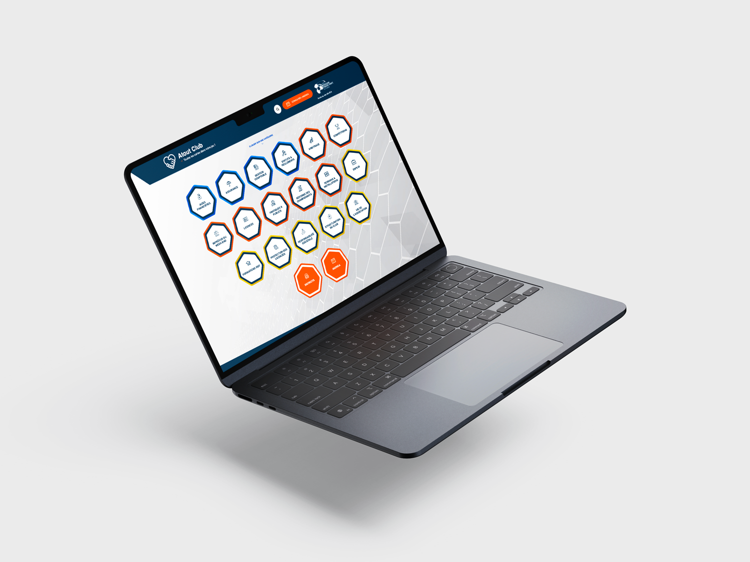 Image d'un ordinateur portable ouvert sur une table montrant un écran affichant une interface utilisateur avec des icônes hexagonales colorées, certaines avec des symboles et des textes, sur le site Ligue de Foot.